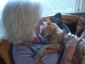 Gail cuddling orange cat