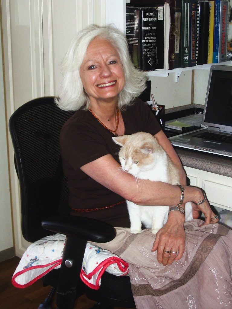 Gail Pope hugging a white and brown cat