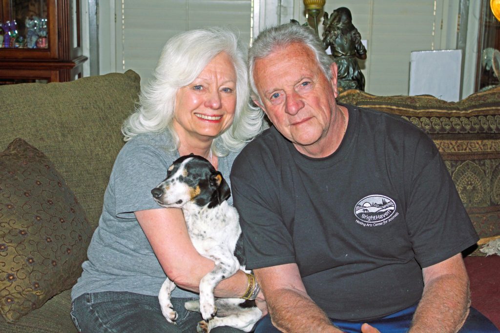 Photo of Gail and Richard with a dog who is blind