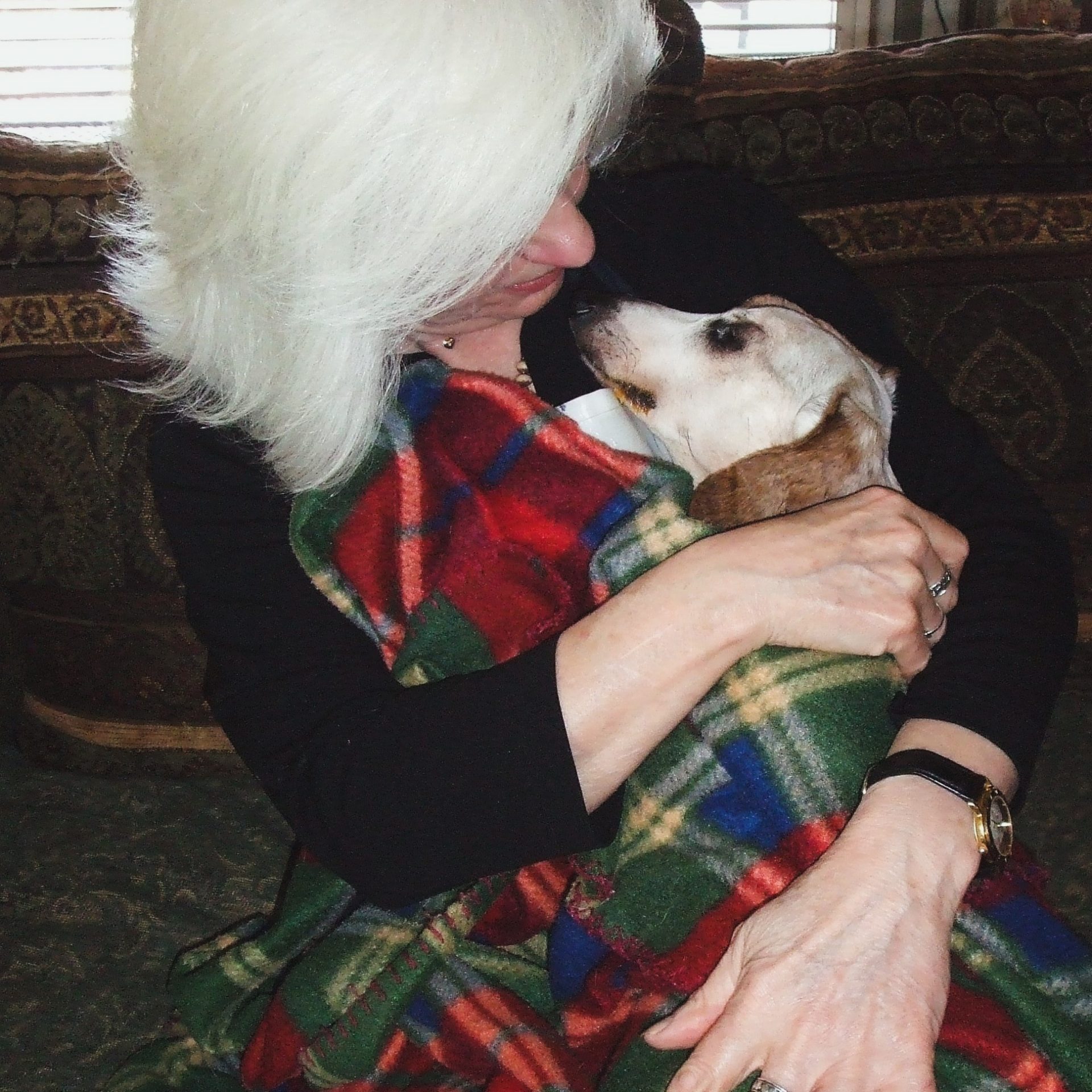 Gail Pope snuggling with a very sick dog