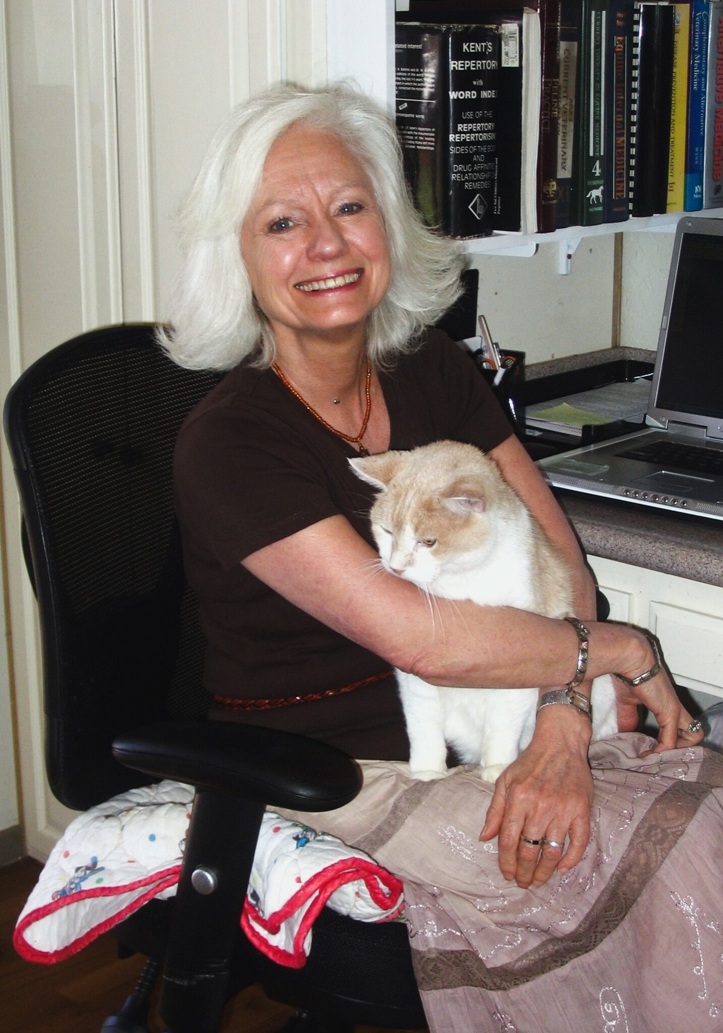Gail Pope hugging a white and brown cat