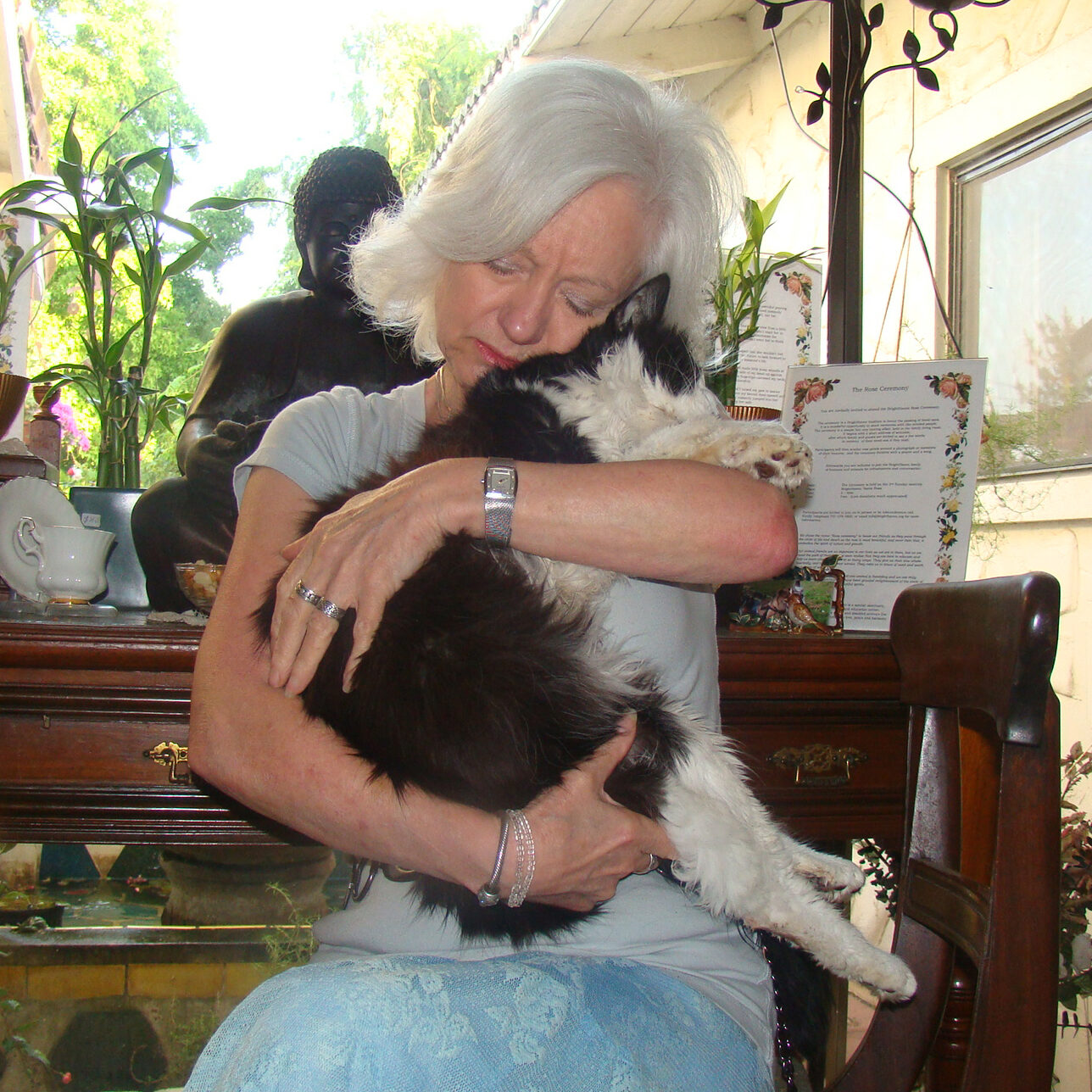 Gail Pope snuggling to a very sick cat